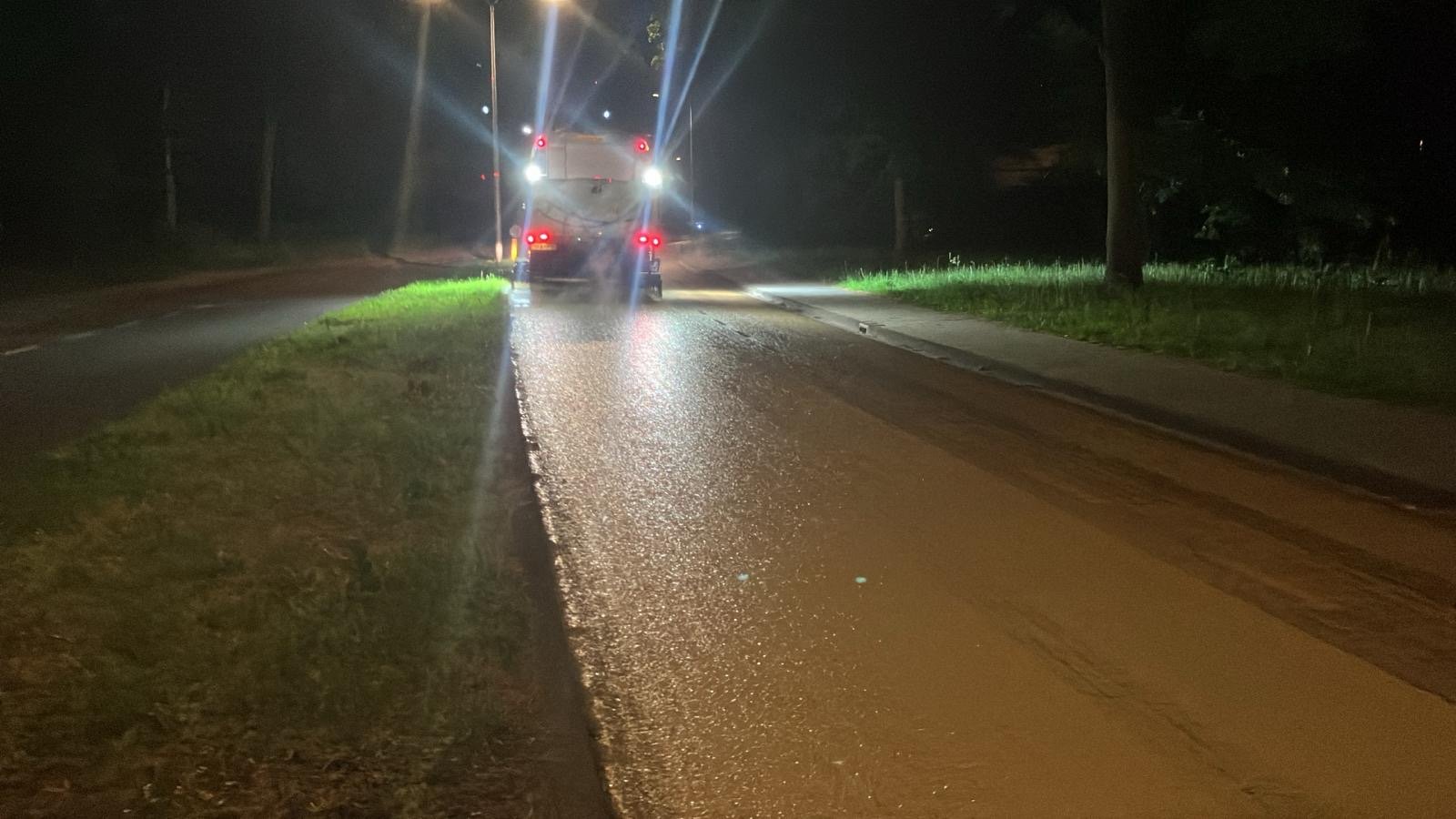Wagen die de emulsie op het wegdek spuit
