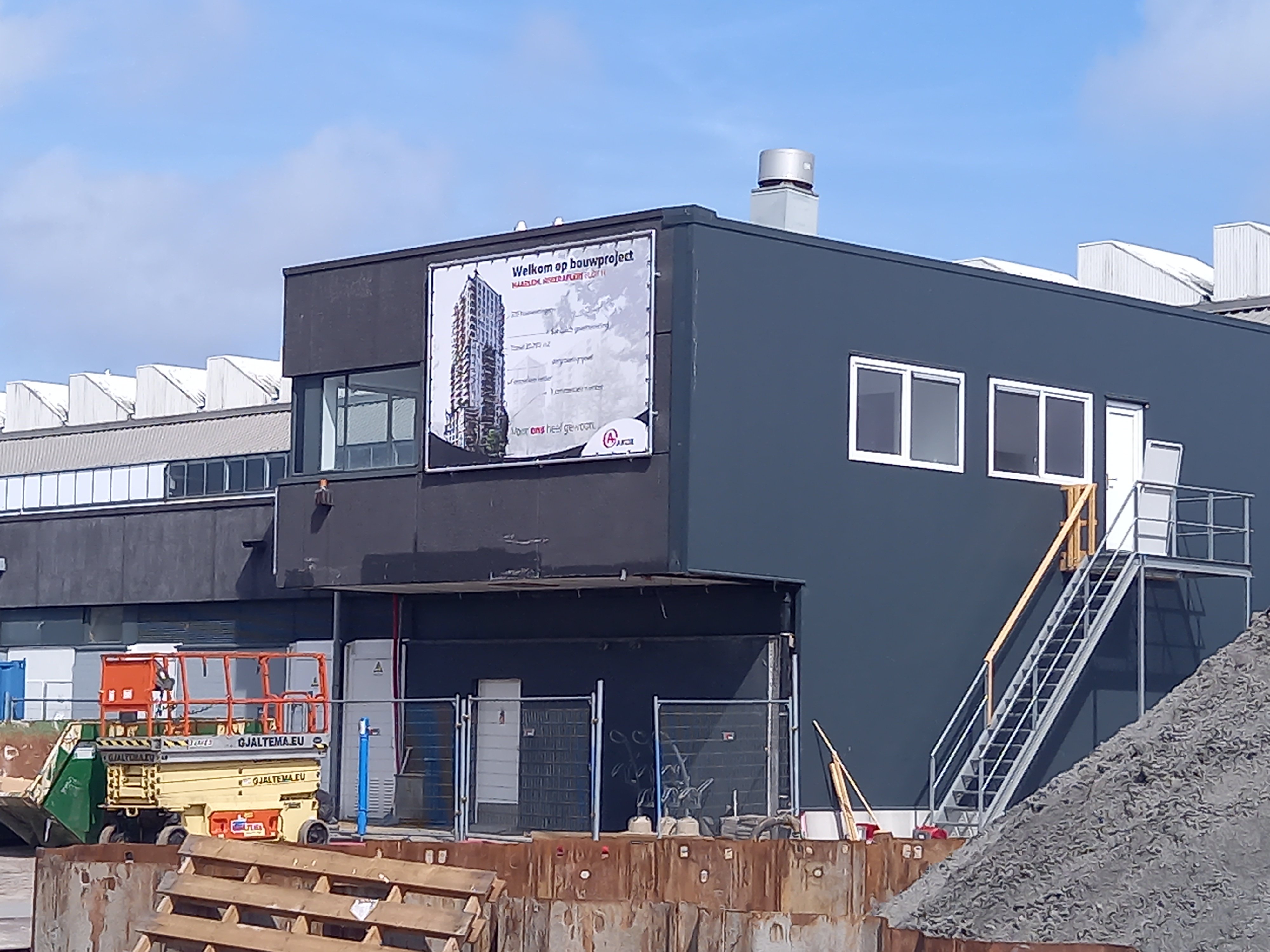 Een bouwkeet met uitzicht op de bouw.