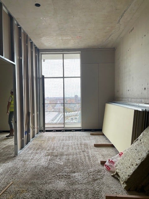 Woonkamer-slaapkamer appartement 24e etage met kenmerkend hoge plafonds