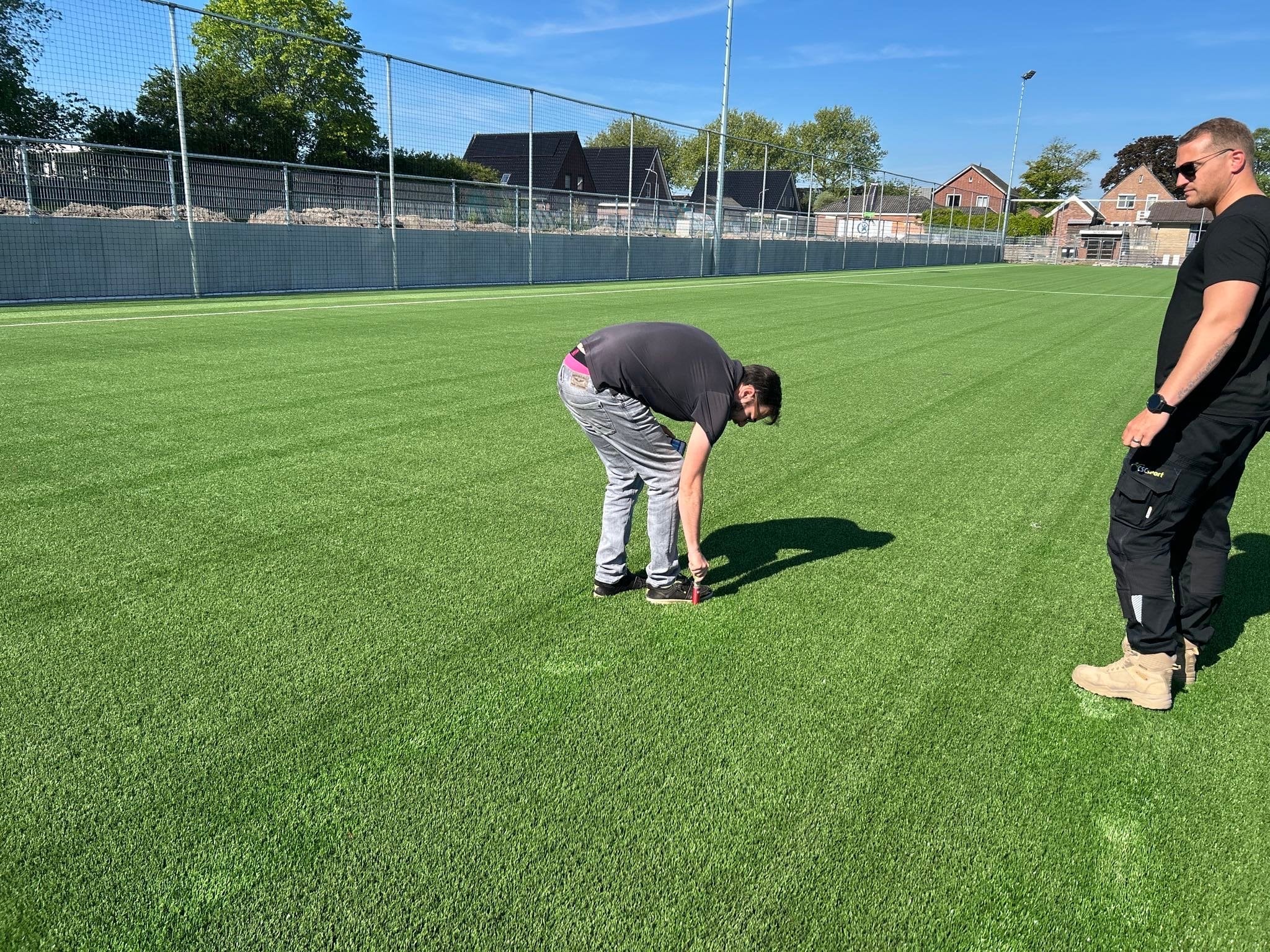 Keuring van het aangebrachte en ingeborstelde zand. De hoeveelheid zand moet liggen tussen de 20-22mm.